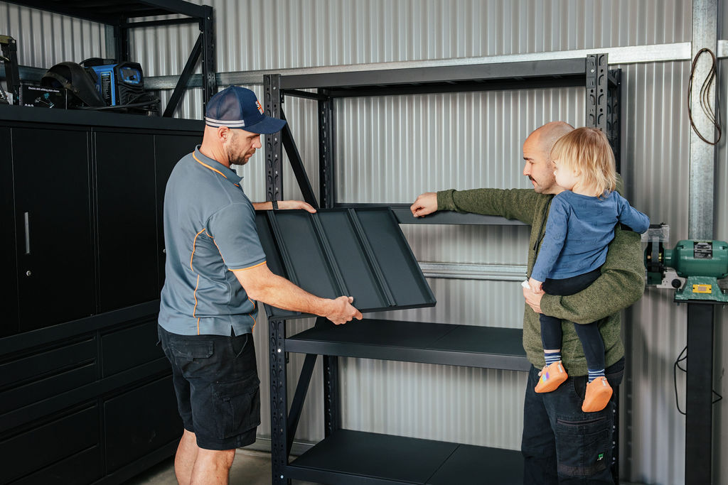 Ben and customer who is a dad showing him shelves for his garage